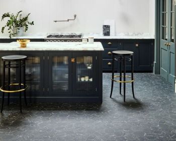 Luxe dark kitchen island with marble worktop and dark grey vinyl flooring